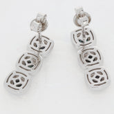 Sterling silver earrings with geometric design, featuring three interlinked square pendants.